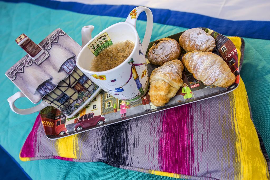 Marshal Garden Hotel Bucureşti Ngoại thất bức ảnh A cup of tea with a selection of pastries